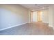 Spacious dining area with wood-look tile flooring and access to backyard at 16430 W Desert Mirage Dr, Surprise, AZ 85388