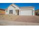 Charming house featuring a white exterior, gray shutters, and a brick driveway at 16430 W Desert Mirage Dr, Surprise, AZ 85388