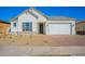 One-story home with white exterior, gray shutters, and a two-car garage at 16430 W Desert Mirage Dr, Surprise, AZ 85388