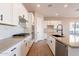 Bright kitchen showcasing white cabinets, quartz countertops, and a center island at 16430 W Desert Mirage Dr, Surprise, AZ 85388