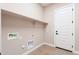 Laundry room with built in shelving and door at 16430 W Desert Mirage Dr, Surprise, AZ 85388