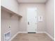 Laundry room with built-in shelving and door at 16430 W Desert Mirage Dr, Surprise, AZ 85388