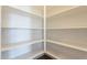 Well-lit pantry with ample shelving for storage at 16430 W Desert Mirage Dr, Surprise, AZ 85388