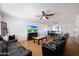 Living room featuring leather sofas, a fireplace, and a large TV at 4833 N 69Th Dr, Phoenix, AZ 85033