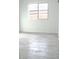 Bedroom with stylish tile floors, neutral paint, and natural light from the large window at 15463 W Mescal St, Surprise, AZ 85379