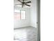 Bedroom with ceiling fan, neutral paint, stylish tile floors, and natural window light at 15463 W Mescal St, Surprise, AZ 85379