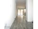 Hallway with light-colored flooring that leads to the sliding glass door at 15463 W Mescal St, Surprise, AZ 85379