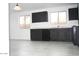 Kitchen showcasing dark cabinetry, stainless steel appliances, and light-colored floors at 15463 W Mescal St, Surprise, AZ 85379