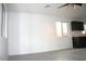 Bright living room with light-colored flooring, bright white walls and dark kitchen cabinets at 15463 W Mescal St, Surprise, AZ 85379