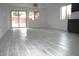 Spacious living area with a glass sliding door, light-colored flooring and an open floor plan at 15463 W Mescal St, Surprise, AZ 85379