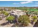 Beautiful aerial view of a home with a circular design situated in a golf community at 9853 E Sundance Trl, Scottsdale, AZ 85262