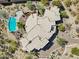 An aerial view of the unique home, showing the pool, circular design, and desert landscaping at 9853 E Sundance Trl, Scottsdale, AZ 85262