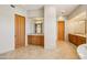 Open bathroom area with tile floors and wood cabinets with granite countertops at 9853 E Sundance Trl, Scottsdale, AZ 85262