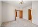 Spacious bedroom with gray carpet, featuring multiple entry doors and an attached bathroom at 9853 E Sundance Trl, Scottsdale, AZ 85262