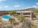 Beautiful home featuring a private pool, stone accents, and gorgeous desert surroundings at 9853 E Sundance Trl, Scottsdale, AZ 85262