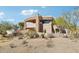 Exterior of a modern desert home with balconies and stone accents at 9853 E Sundance Trl, Scottsdale, AZ 85262