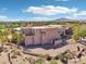 Exterior of a beautiful home with a three car garage and lovely desert landscaping at 9853 E Sundance Trl, Scottsdale, AZ 85262