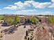 Beautiful contemporary home showcasing a curved driveway and lush desert surroundings at 9853 E Sundance Trl, Scottsdale, AZ 85262
