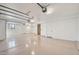 Bright three-car garage with white walls, epoxy flooring, and ample storage space at 9853 E Sundance Trl, Scottsdale, AZ 85262