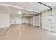Spacious three-car garage with white walls and epoxy flooring at 9853 E Sundance Trl, Scottsdale, AZ 85262