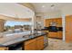 Well-lit kitchen with granite countertops, island, and breakfast nook with a view at 9853 E Sundance Trl, Scottsdale, AZ 85262