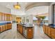 Open kitchen features custom cabinets, granite counters, and views of outdoor living space, pool, and golf course at 9853 E Sundance Trl, Scottsdale, AZ 85262