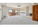 Expansive living room with a fireplace, backyard access, and desert views at 9853 E Sundance Trl, Scottsdale, AZ 85262