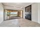 Open living room with tile floors, fireplace, and a wall of glass that opens to the pool at 9853 E Sundance Trl, Scottsdale, AZ 85262