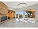 Spacious living room with fireplace, built-in shelves, and large windows with golf course views at 9853 E Sundance Trl, Scottsdale, AZ 85262