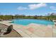 Backyard pool with clear blue water overlooks views of desert landscape and a golf course at 9853 E Sundance Trl, Scottsdale, AZ 85262