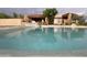 Inviting pool with cool, refreshing water and views of the stone-accented exterior of this desert home at 9853 E Sundance Trl, Scottsdale, AZ 85262