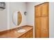 Elegant powder room with a marble countertop vanity, round mirror, and matching wood cabinets at 9853 E Sundance Trl, Scottsdale, AZ 85262