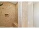 Close-up of tiled walk-in shower with a built-in bench and toiletry cubby at 9853 E Sundance Trl, Scottsdale, AZ 85262
