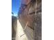 Narrow exterior alleyway between two homes with boarded up areas at 1006 S 3Rd Ave, Phoenix, AZ 85003