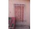 This window is covered with plywood and a decorative white metal grate over the top at 1006 S 3Rd Ave, Phoenix, AZ 85003