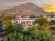 Desert home featuring a pristine pool, solar panels, red tile roof, and mountain views at 10721 E La Junta Rd, Scottsdale, AZ 85255