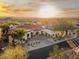 Expansive desert home boasting a red tile roof, circular driveway, and stunning sunset views at 10721 E La Junta Rd, Scottsdale, AZ 85255