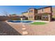 A stunning backyard with a sparkling pool and lush artificial turf, stone pavers, perfect for outdoor relaxation and entertainment at 12687 W Caraveo Pl, Peoria, AZ 85383