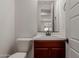 Well-lit half bathroom with sleek fixtures, vanity, and a modern toilet at 12687 W Caraveo Pl, Peoria, AZ 85383