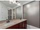 Bathroom featuring a double vanity with granite countertop and a shower at 12687 W Caraveo Pl, Peoria, AZ 85383