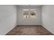 Bright, empty room with wood-look tile flooring and natural light, perfect for customization at 12687 W Caraveo Pl, Peoria, AZ 85383