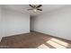 Bedroom featuring neutral walls, brown carpet, and a ceiling fan at 12687 W Caraveo Pl, Peoria, AZ 85383