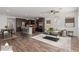 Inviting open-concept living room with a kitchen island, stainless steel appliances, and stylish modern furniture at 12687 W Caraveo Pl, Peoria, AZ 85383
