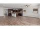 Open-concept living room with tile flooring, recessed lighting, and seamless flow to the kitchen at 12687 W Caraveo Pl, Peoria, AZ 85383