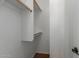 A view of the walk-in closet with white walls and a wood shelf at 12687 W Caraveo Pl, Peoria, AZ 85383
