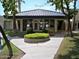 Charming clubhouse featuring a unique roof design, lush landscaping, and inviting entrance at 5132 N 31St Way # 114, Phoenix, AZ 85016