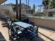 Outdoor patio seating area with blue table and chairs near the community pool, perfect for relaxing at 5132 N 31St Way # 114, Phoenix, AZ 85016