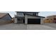 Charming two-story home featuring a modern black garage door and inviting front entrance at 6134 S Borego Rd, Gold Canyon, AZ 85118