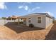 View of the home's backyard with block fence, covered patio and rear exterior of the home at 18174 W Pima St, Goodyear, AZ 85338