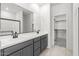 Modern bathroom with double sinks, a large mirror, and tiled floor at 18174 W Pima St, Goodyear, AZ 85338